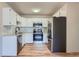 Updated kitchen features stainless steel appliances, white cabinets, and modern backsplash at 3184 S Heather Gardens Way # 302, Aurora, CO 80014