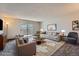 Spacious living room featuring plush seating, stylish decor, and sliding glass doors to a balcony at 3184 S Heather Gardens Way # 302, Aurora, CO 80014