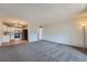 Open concept living room featuring gray carpet, a modern kitchen, and ample natural light at 3184 S Heather Gardens Way # 302, Aurora, CO 80014