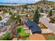 Stunning aerial view of the home, backyard, and wooden deck with neighborhood views beyond at 129 Gordon Pl, Castle Rock, CO 80104