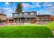 This home features a spacious, turfed backyard with a large wooden deck and fencing at 129 Gordon Pl, Castle Rock, CO 80104