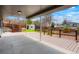 Covered patio with a view of the wooden deck, fenced yard, shed, and spring greenery at 129 Gordon Pl, Castle Rock, CO 80104