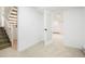 Bright basement area with neutral carpet, staircase, and an open doorway at 129 Gordon Pl, Castle Rock, CO 80104