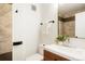 Stylish bathroom with white vanity, framed mirror, and decorative plants, with tiled shower at 129 Gordon Pl, Castle Rock, CO 80104