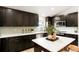 Modern kitchen featuring dark cabinetry, stainless steel appliances, and white countertops at 129 Gordon Pl, Castle Rock, CO 80104