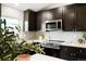 Modern kitchen offers stainless steel appliances and dark cabinetry with a stylish design at 129 Gordon Pl, Castle Rock, CO 80104