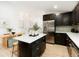 Stylish eat-in kitchen featuring an island, stainless appliances, and a modern open floor plan at 129 Gordon Pl, Castle Rock, CO 80104