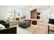 Inviting living room with a decorative rug, modern furniture, and a view of the staircase at 129 Gordon Pl, Castle Rock, CO 80104