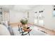 Cozy living room with neutral decor, French doors, and hardwood floors perfect for relaxing or entertaining at 129 Gordon Pl, Castle Rock, CO 80104