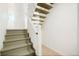 Painted wooden staircase leading to the upper floors with white risers and neutral treads at 129 Gordon Pl, Castle Rock, CO 80104
