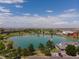 Scenic aerial view of a community featuring a pond, clubhouse, and well-maintained green spaces, offering a tranquil setting at 15501 Fairway Dr, Commerce City, CO 80022