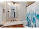 Bathroom with a granite countertop, tile backsplash, and a shower/tub with blue curtain at 15501 Fairway Dr, Commerce City, CO 80022