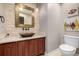 Modern bathroom featuring a copper sink, quartz countertops, and a wood vanity at 15501 Fairway Dr, Commerce City, CO 80022