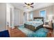 Bedroom featuring hardwood floors, ample windows, and a ceiling fan at 15501 Fairway Dr, Commerce City, CO 80022