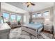 Bright bedroom featuring a ceiling fan, a light wood bed, and large windows with lots of natural light at 15501 Fairway Dr, Commerce City, CO 80022