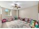 Spacious bonus room featuring neutral walls, a ceiling fan, and an area rug at 15501 Fairway Dr, Commerce City, CO 80022