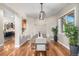 Bright dining room featuring wood floors, a modern chandelier, and ample natural light at 15501 Fairway Dr, Commerce City, CO 80022