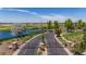 Gated community entrance with a scenic view of a golf course and pond, creating a welcoming and secure environment at 15501 Fairway Dr, Commerce City, CO 80022