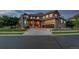Charming two-story house featuring a stone facade, three-car garage, and well-maintained landscaping at 15501 Fairway Dr, Commerce City, CO 80022