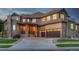 Stunning two-story home with a stone facade, a circular driveway, and a three-car garage at 15501 Fairway Dr, Commerce City, CO 80022
