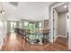 Open second-story hallway with ornate iron railing overlooking the main level and an abundance of natural light at 15501 Fairway Dr, Commerce City, CO 80022