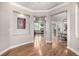 Bright, spacious hallway featuring wood floors and stylish architectural details at 15501 Fairway Dr, Commerce City, CO 80022