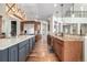 Spacious kitchen featuring an oversized island with prep sink, stainless appliances, and a view of the upper level at 15501 Fairway Dr, Commerce City, CO 80022