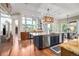 Open kitchen with an island, a full set of stainless steel appliances, and hardwood floors at 15501 Fairway Dr, Commerce City, CO 80022