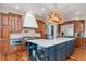 Gorgeous kitchen featuring custom cabinets, stainless steel appliances, and an oversized kitchen island at 15501 Fairway Dr, Commerce City, CO 80022