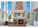 Stunning living room showcasing fireplace and an abundance of natural light from the large windows at 15501 Fairway Dr, Commerce City, CO 80022