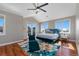 Main bedroom featuring a vaulted ceiling, ceiling fan, windows, and a balcony at 15501 Fairway Dr, Commerce City, CO 80022