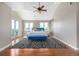 Spacious main bedroom with a ceiling fan, wood floors, and access to a balcony at 15501 Fairway Dr, Commerce City, CO 80022