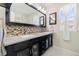 Elegant bathroom with a double vanity and mosaic tile backsplash at 5603 W 118Th Pl, Broomfield, CO 80020