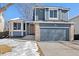 Two-story house with gray siding, a two-car garage, and a well-maintained lawn at 5603 W 118Th Pl, Broomfield, CO 80020