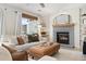 Cozy living room with fireplace, seating, and a ceiling fan at 5603 W 118Th Pl, Broomfield, CO 80020