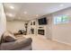 Finished basement with a fireplace and workout equipment at 9743 Chanteclair Cir, Highlands Ranch, CO 80126