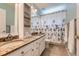 Bathroom with double sinks, granite counters, and a decorative shower curtain at 9743 Chanteclair Cir, Highlands Ranch, CO 80126