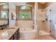 Bright bathroom featuring a soaking tub, glass-enclosed shower, and modern fixtures at 9743 Chanteclair Cir, Highlands Ranch, CO 80126