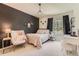 Chic bedroom with a stylish accent wall, chandelier, and comfortable furnishings at 9743 Chanteclair Cir, Highlands Ranch, CO 80126