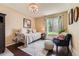Cozy bedroom featuring a daybed, plush furnishings, and a window with a view of the outdoor greenery at 9743 Chanteclair Cir, Highlands Ranch, CO 80126