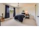 Bright bedroom with a cozy bed, natural light, and minimalist decor at 9743 Chanteclair Cir, Highlands Ranch, CO 80126