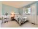 Bright bedroom with a large window and a vanity at 9743 Chanteclair Cir, Highlands Ranch, CO 80126
