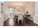 Bright dining room with hardwood floors and elegant chandelier at 9743 Chanteclair Cir, Highlands Ranch, CO 80126