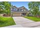 Beautifully landscaped home featuring a spacious driveway and a charming front yard at 9743 Chanteclair Cir, Highlands Ranch, CO 80126