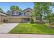 Inviting two-story home with a well-manicured lawn and attractive stone accents at 9743 Chanteclair Cir, Highlands Ranch, CO 80126