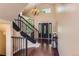 Elegant foyer with hardwood floors, a staircase, and decorative lighting at 9743 Chanteclair Cir, Highlands Ranch, CO 80126