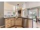 Open-concept kitchen featuring stone countertops and a view of the lush backyard at 9743 Chanteclair Cir, Highlands Ranch, CO 80126
