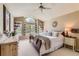 Serene primary bedroom with a large window, ceiling fan, and neutral decor at 9743 Chanteclair Cir, Highlands Ranch, CO 80126