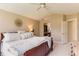 Neutral primary bedroom with a large bed, and a peek at the vanity through an opening in the wall at 9743 Chanteclair Cir, Highlands Ranch, CO 80126