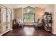 Cozy sitting room featuring a large window, hardwood floors, and stylish decor at 9743 Chanteclair Cir, Highlands Ranch, CO 80126